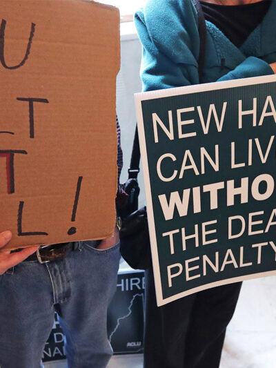 Demonstrators carrying signs advocating the abolition of the death penalty in New Hampshire