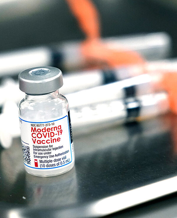 Syringes with doses of the Moderna COVID-19 vaccine on a surgical tray.