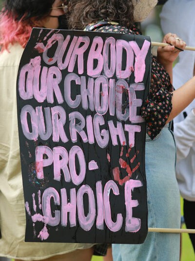 Protester with a sign that says, "Our body our choice our right pro-choice."