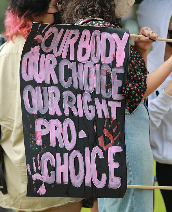 Protester with a sign that says, "Our body our choice our right pro-choice."