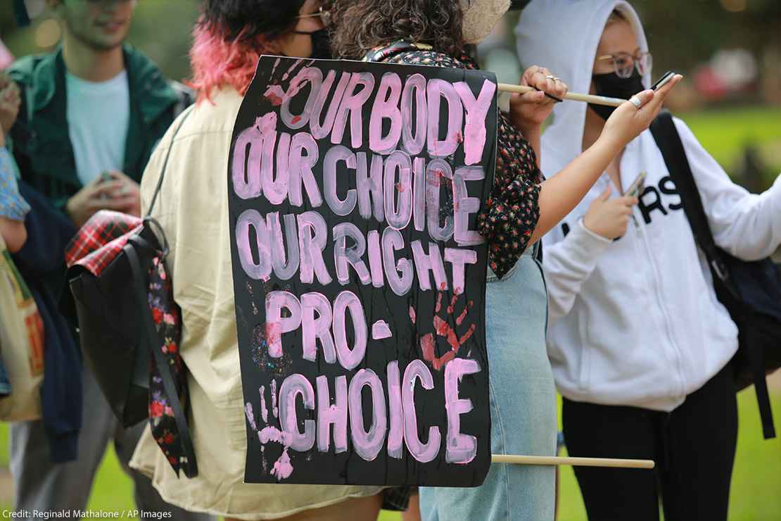 Protester with a sign that says, "Our body our choice our right pro-choice."