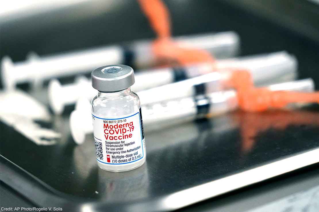 Syringes with doses of the Moderna COVID-19 vaccine on a surgical tray.
