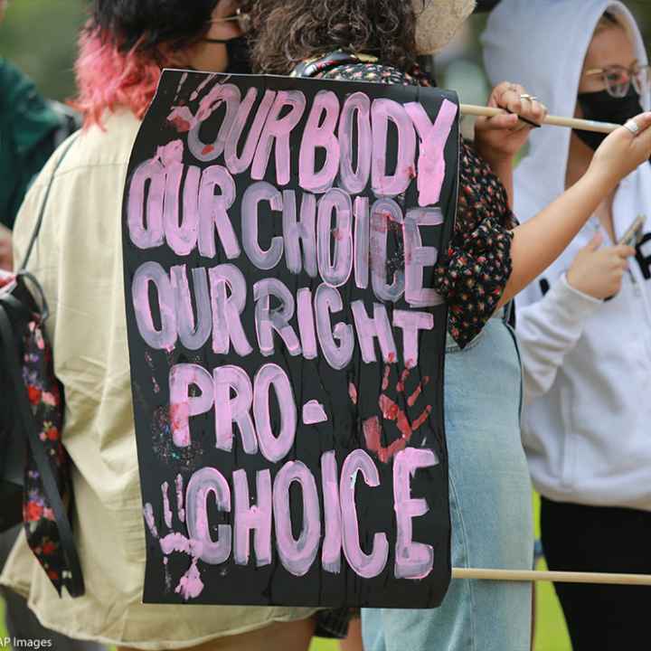 Protester with a sign that says, "Our body our choice our right pro-choice."